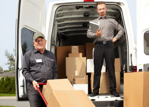 Packed boxes and furniture ready for transport during a Queensbury move