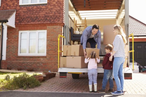 Professional Queensbury movers loading furniture into a van