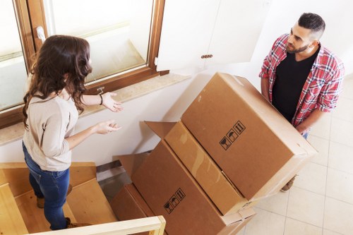 Apartment moving team handling furniture during a Queensbury flat removal
