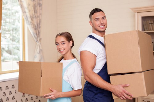Moving crew wearing PPE while carrying items safely